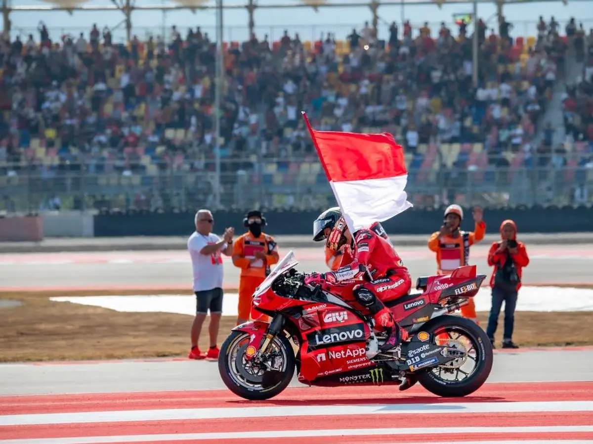 MotoGP race winner celebrating with the Indonesian flag at Mandalika